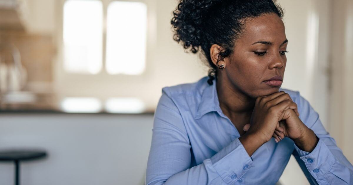 Woman showing signs of anxiety, illustrating the gut-brain connection

