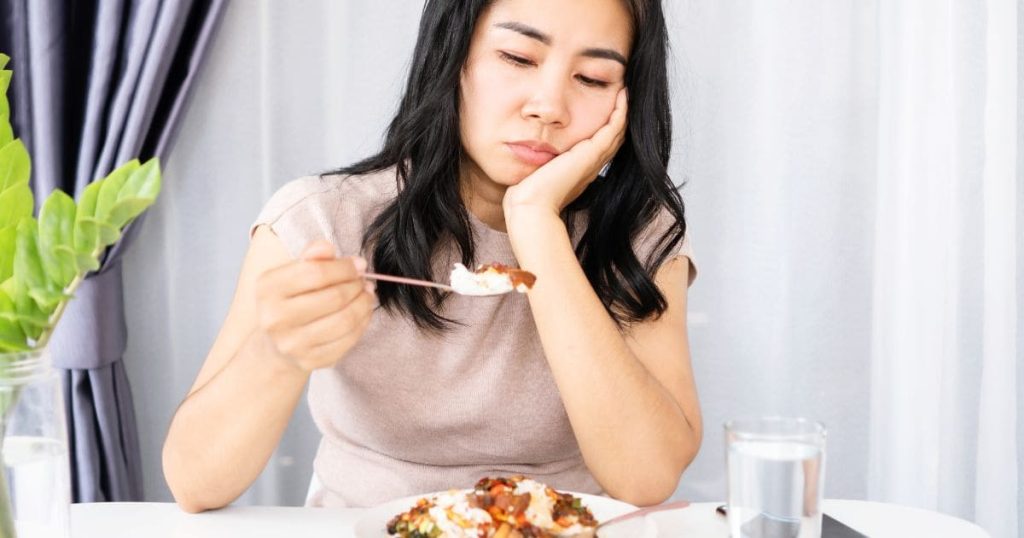 Woman with reduced appetite, illustrating digestive or gut-related symptoms
