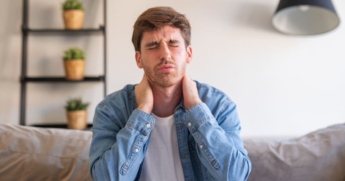 Man with muscle tension, illustrating physical symptoms linked to stress and gut health

