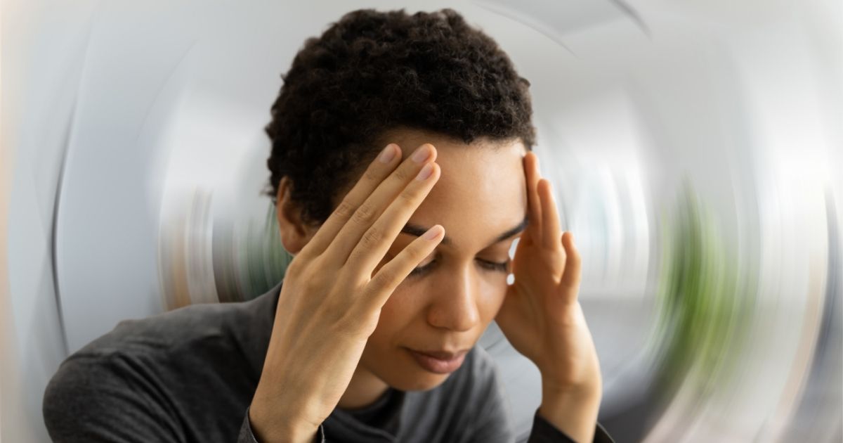Person holding head, looking distressed.